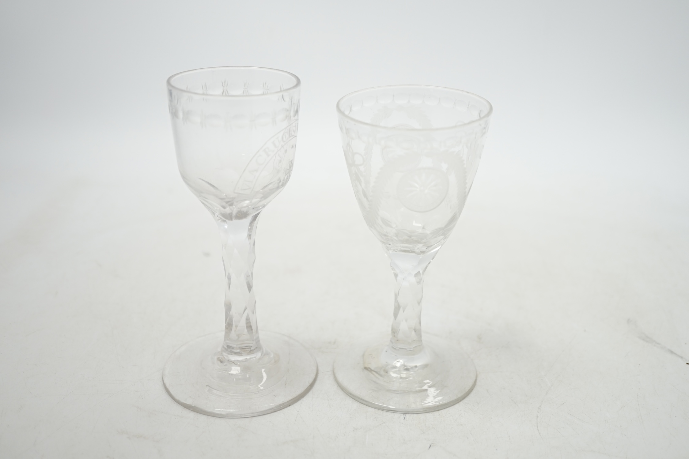Two 18th century wine glasses with faceted stems, both with engraved bowls, one neo-classical and one reading ‘Via Crucis Via Lucis’, tallest 13.5cm. Condition - good